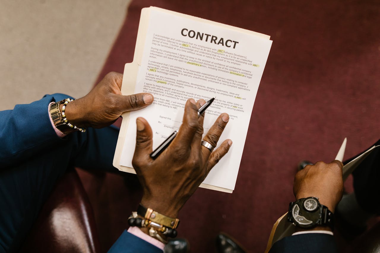 Close-up of a person holding a legal contract document representing AI agents automating contract review
