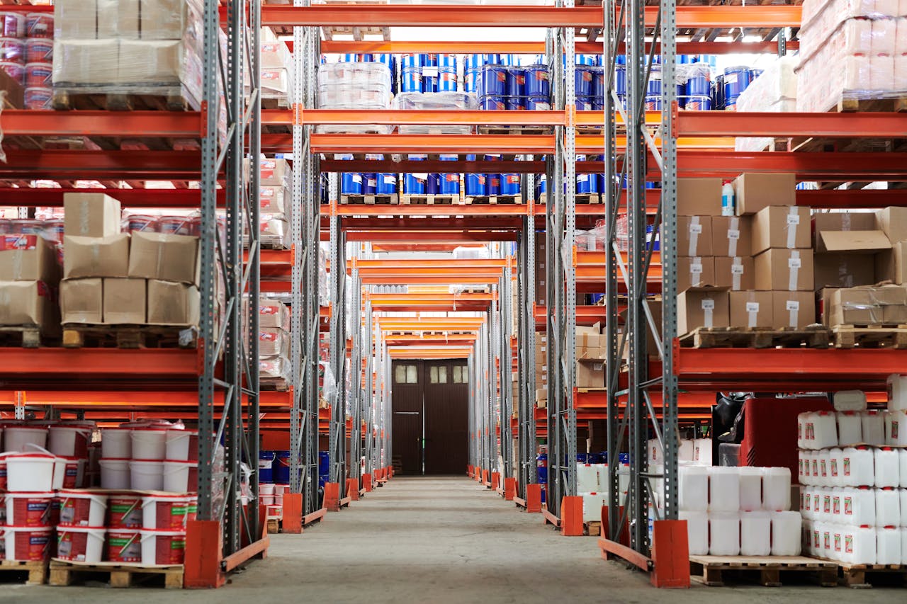 Warehouse aisle with tall shelving and inventory representing AI-driven procurement and supply chain operations