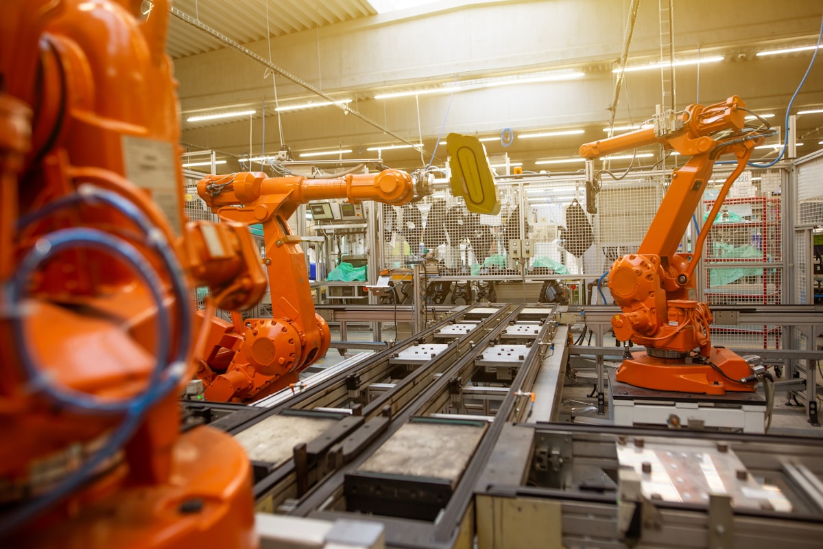 Automated robotic factory production line representing AI software factory agents building code autonomously