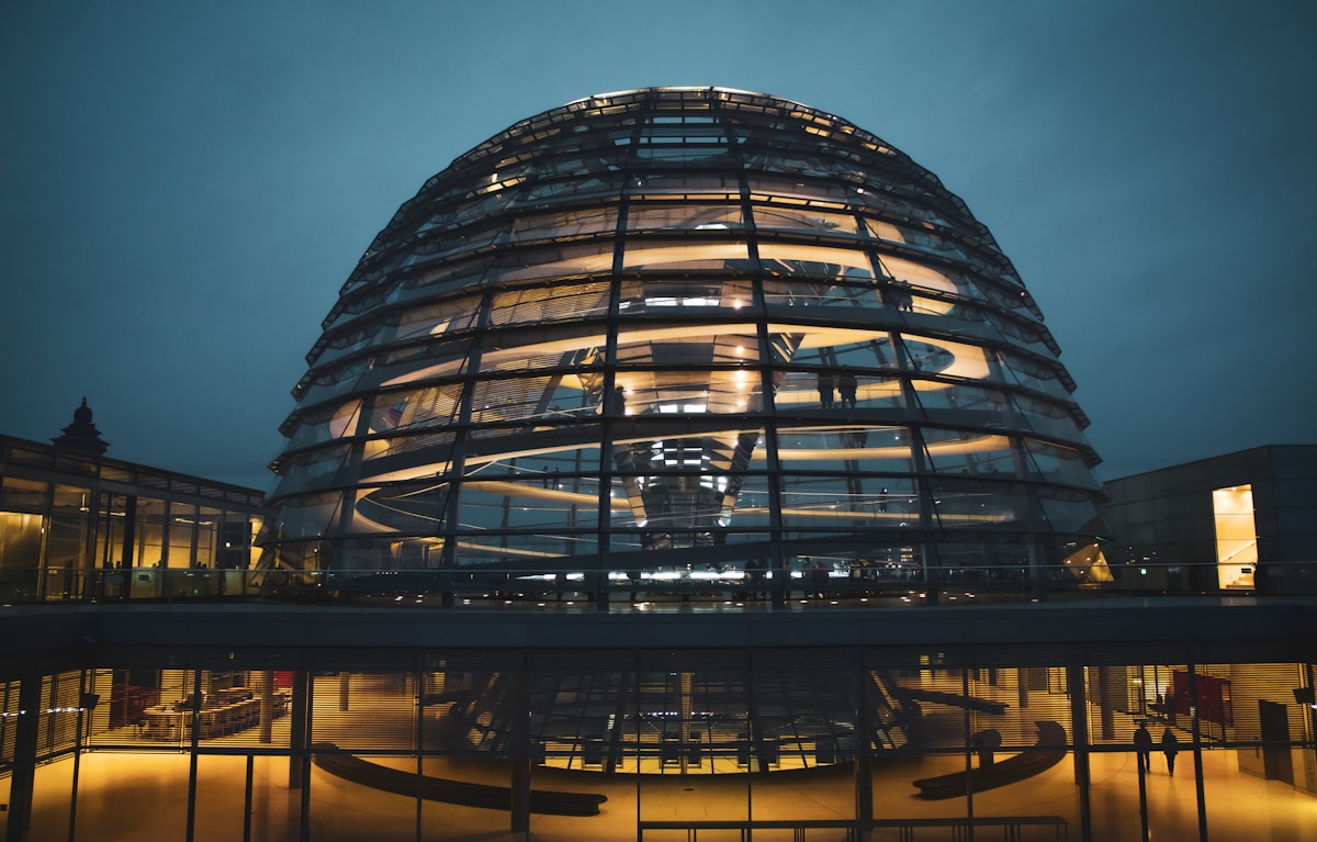 Modern glass dome architecture representing Germany's need for an AI Safety Institute and transparent AI governance